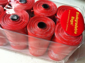 Rolls of red poo bags