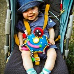 Dominic smiling in his pram with a nasogastric feeding tube